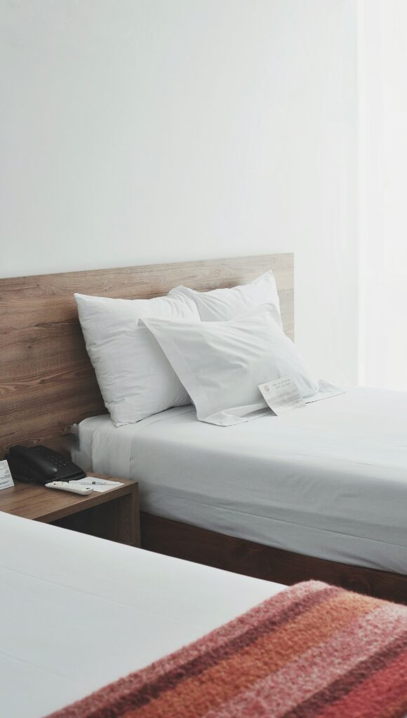 Two single beds in a bright hotel room